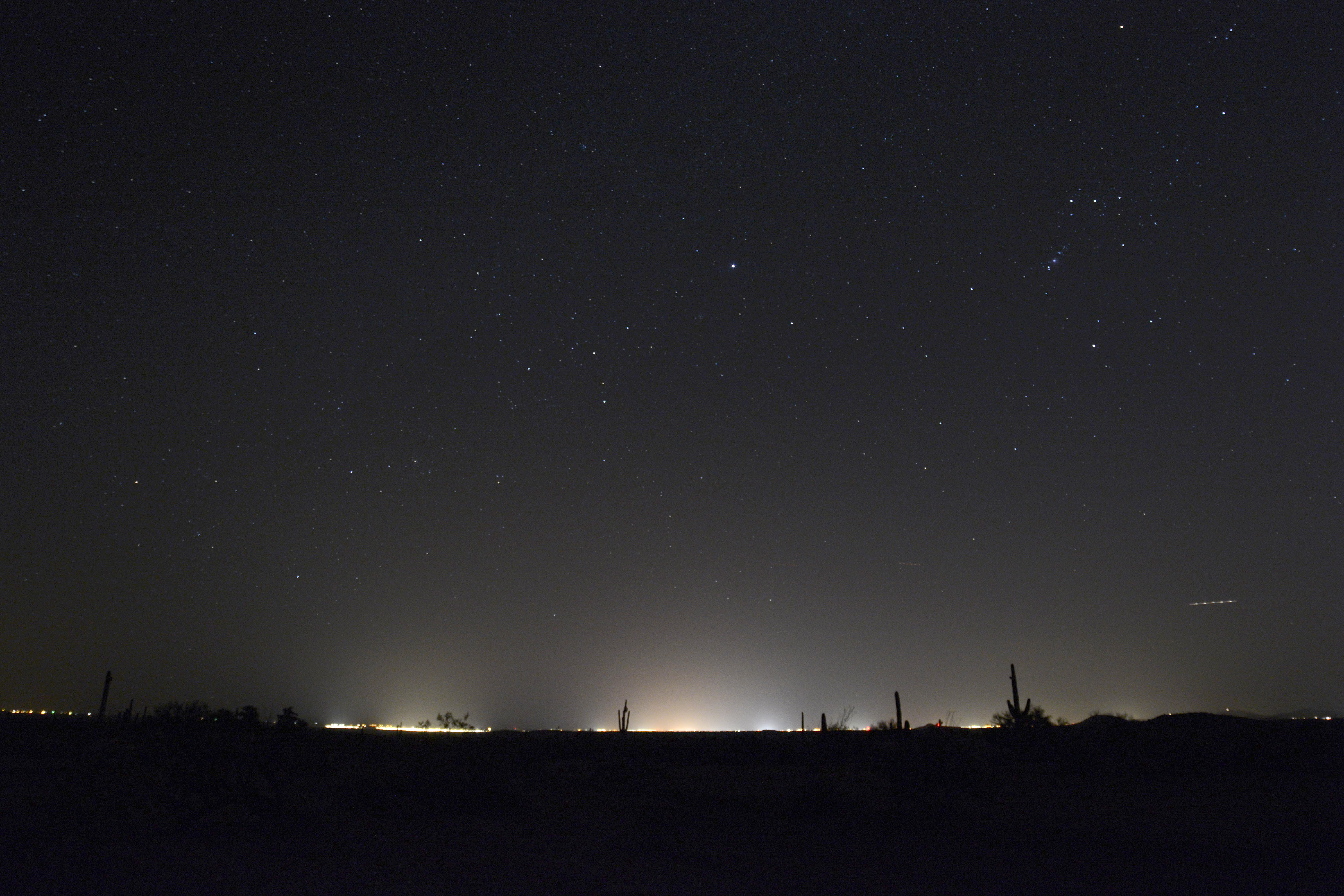 The glow of city lights from Phoenix mars the horizon as seen from Surprise, Arizona, some 55 miles (89 km) away. 