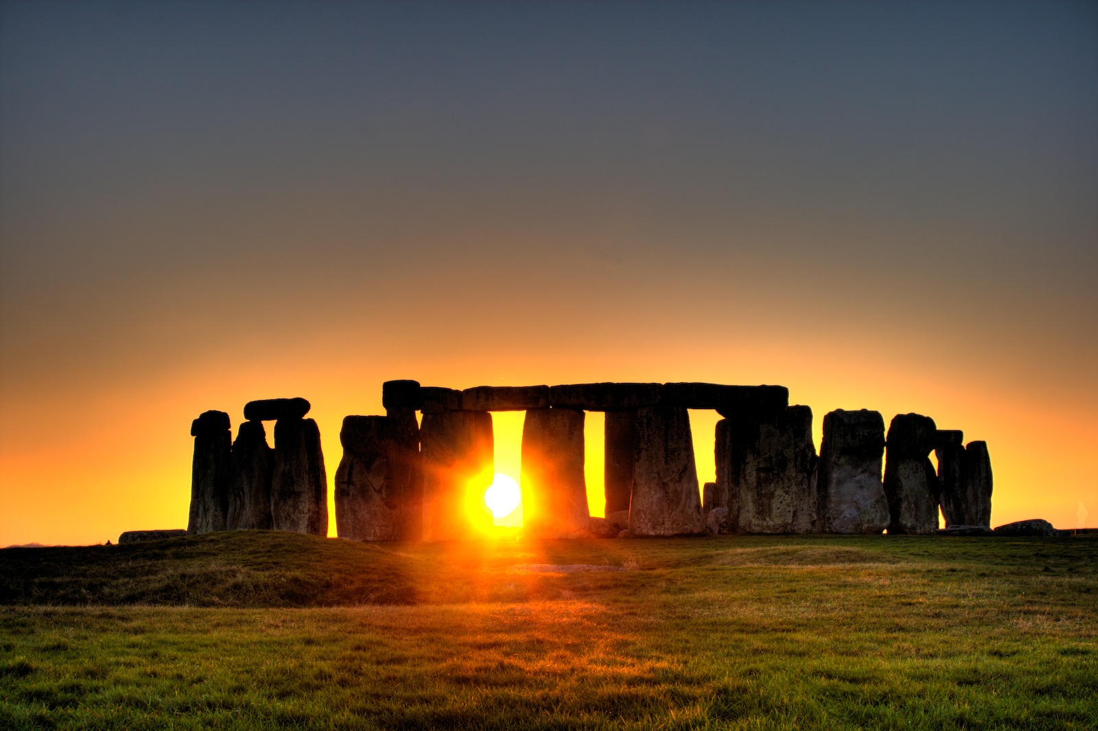 The Sun rises at Stonehenge.