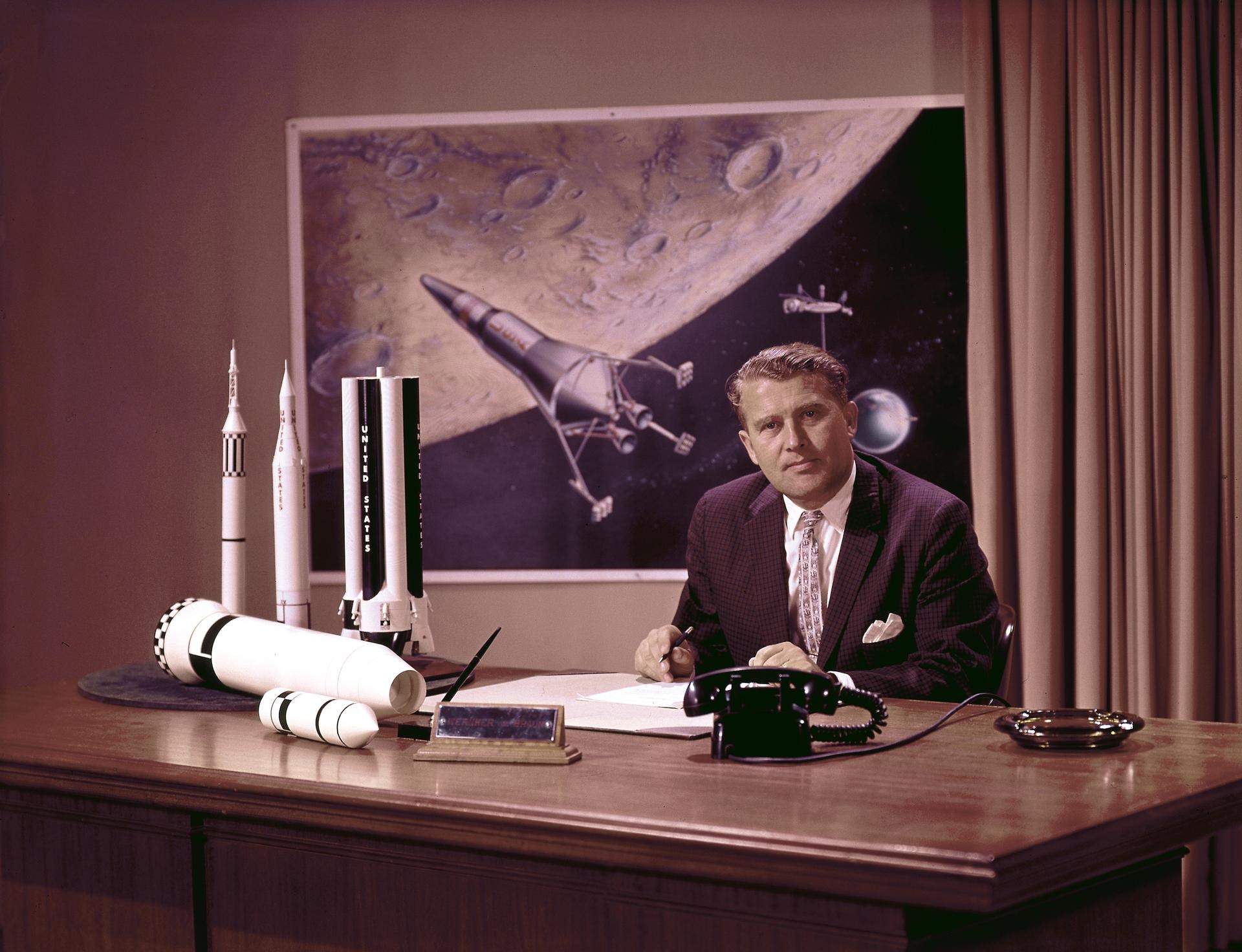 Wernher von Braun poses at his desk at the Marshall Space Flight Center (MSFC). Credit: NASA.