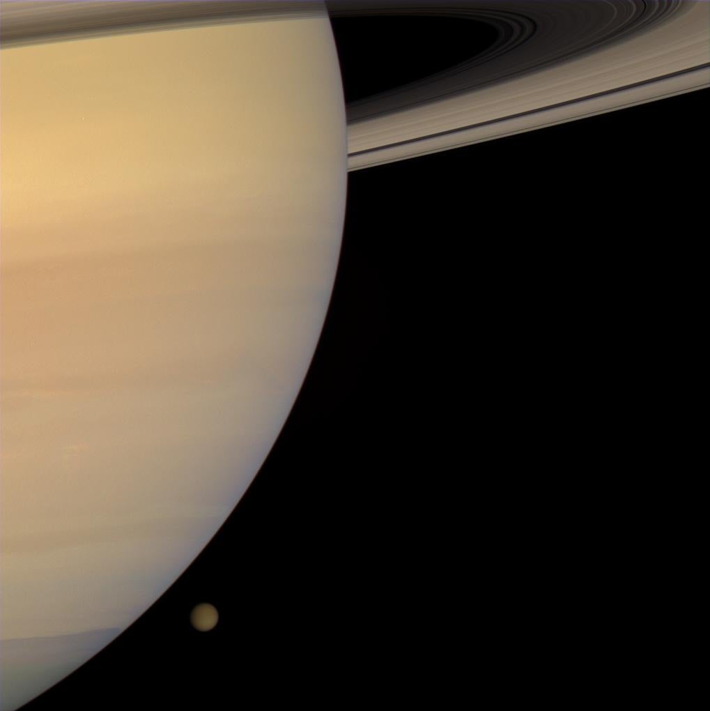 The Cassini spacecraft captured this color portrait of Saturn and Titan only a few minutes before the haze-enshrouded moon slipped behind the planet's enormous bulk. Credit: NASA/JPL.