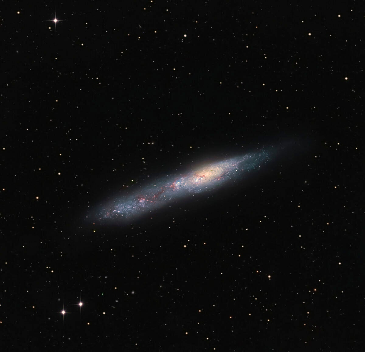 NGC 55’s oblong shape gives it an uncanny resemblances to the Cigar Galaxy (M82). 