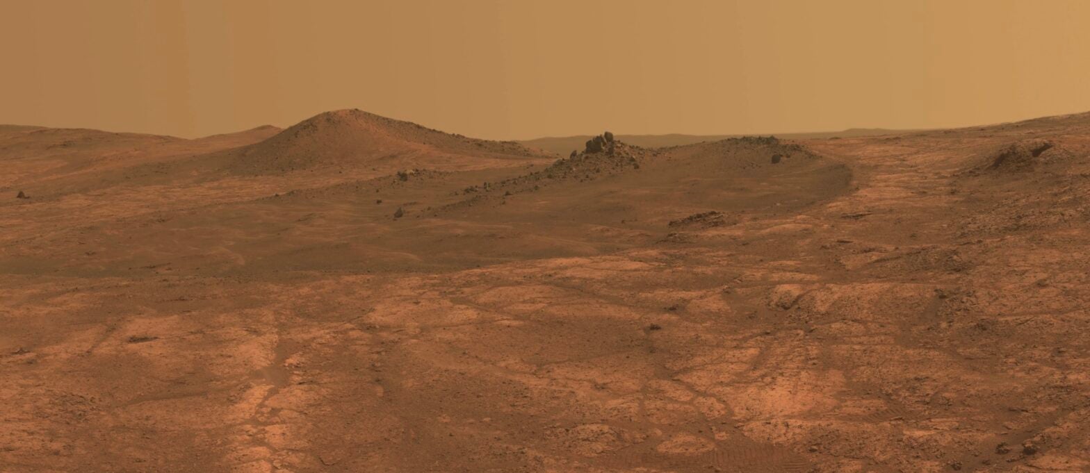 An elongated crater called "Spirit of St. Louis," with a rock spire in it, dominates a recent scene from the panoramic camera (Pancam) on NASA's Mars Exploration Rover Opportunity.