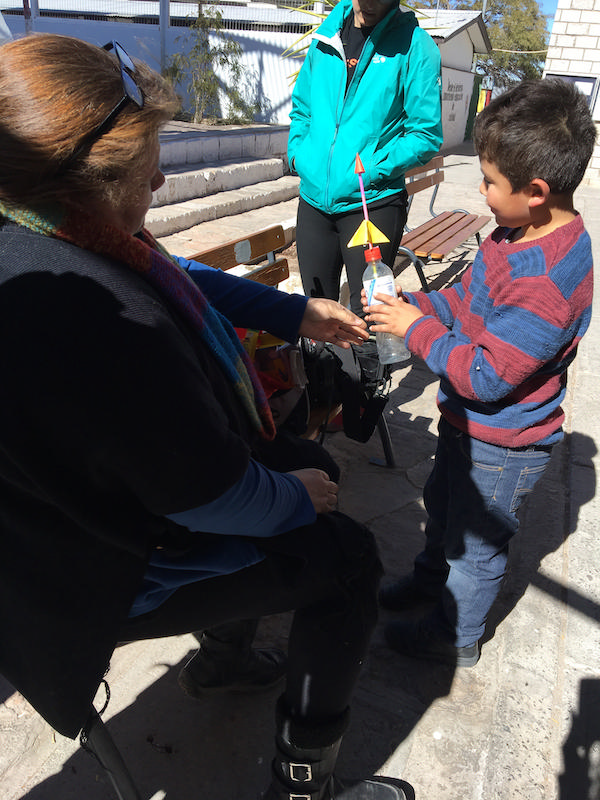 Young student with bottle rocket