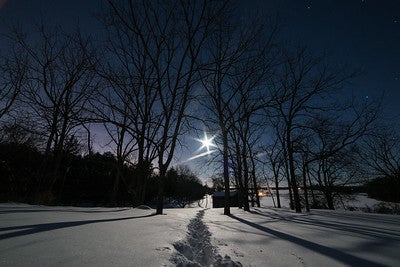 Full Moon shining over snowy landscape