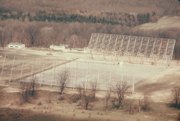 The Big Ear Radio Telescope's unique design allowed staff to build it relatively inexpensively, but it was still capable of making fundamental breakthroughs in radio astronomy.
NRAO/John Daniel Kraus
But Big Ear didn’t look like other radio telescopes. It looked like someone covered a football field in white paint and installed bleachers at either end behind the goalposts. These “bleachers” were actually feed horns to funnel radio signals from the telescope's large reflector to its receiver.