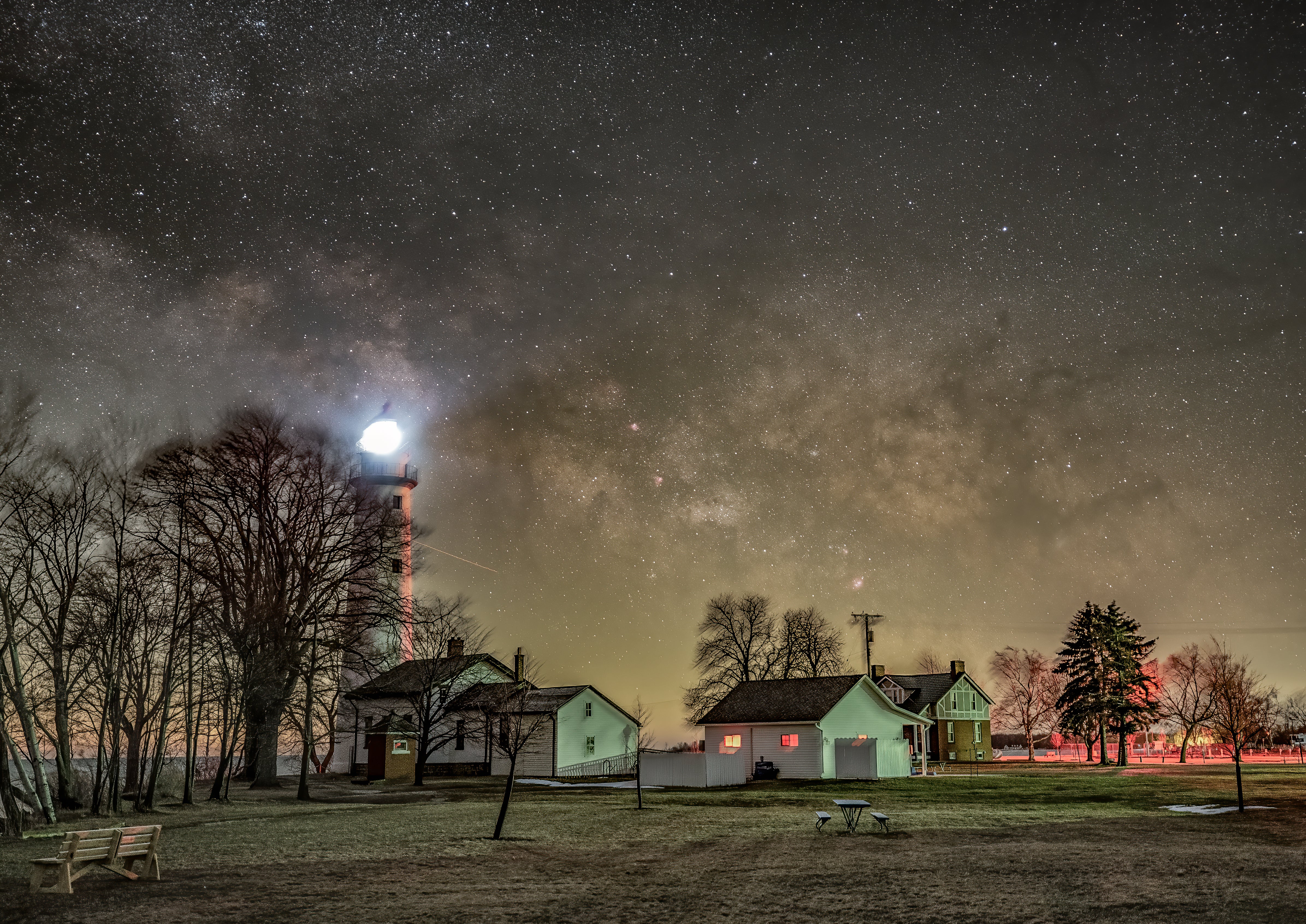 The Milky Way rises over the Point aux Barques Lighthouse on Lake Huron. The two-minute sky and ground frames of this composite were taken at f/2.8 and ISO 1600.