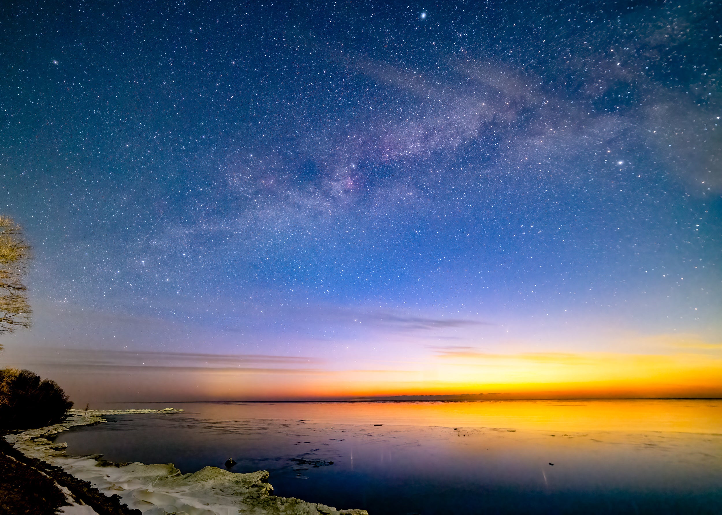 The glow of dawn creeps above the horizon in this image taken from Port Sanilac Roadside Park, overlooking Lake Huron, during nautical twilight. The shot is a 30-second exposure at ISO 6400.