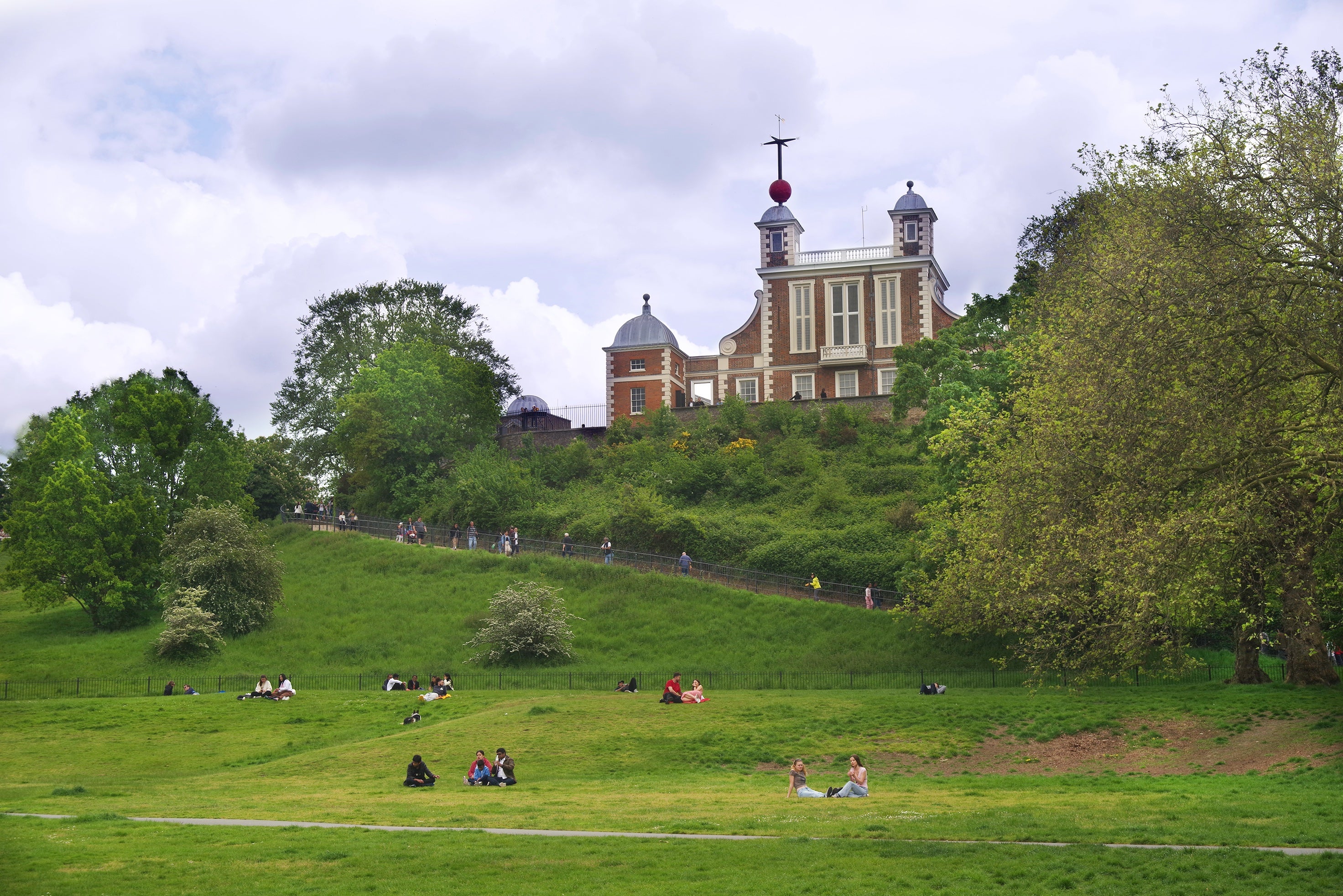 The Royal Observatory Greenwich sits on a hill overlooking Greenwich Park. The red brick building is Flamsteed House, which dates from 1676. 