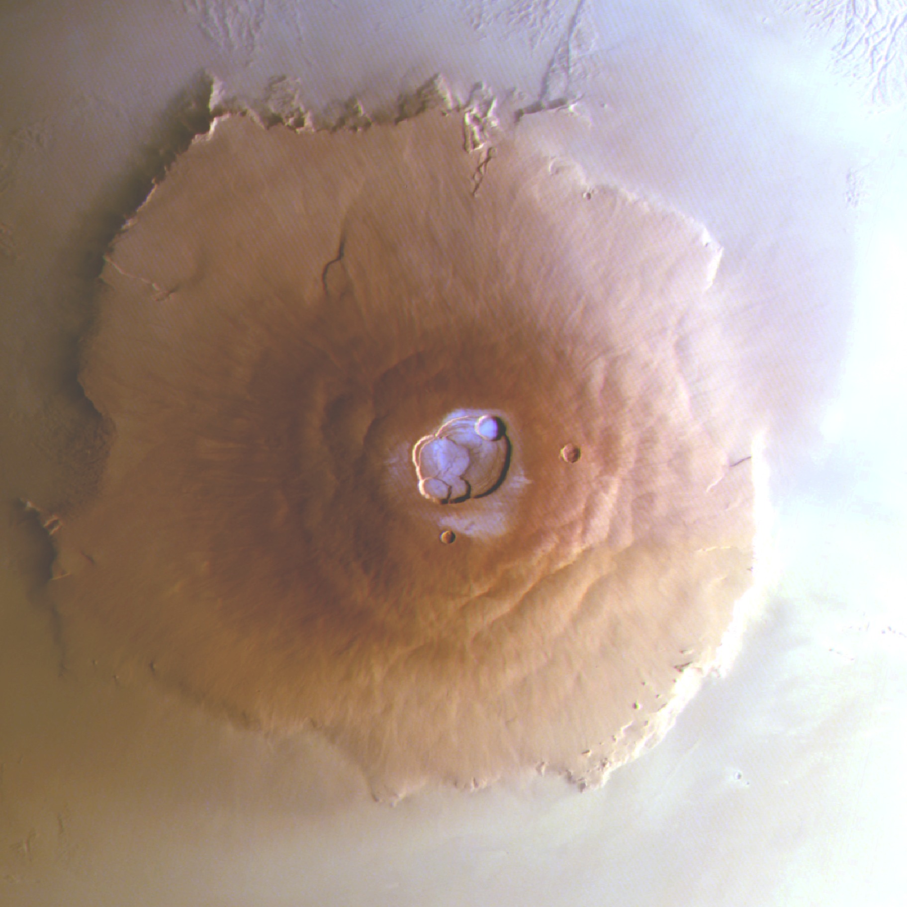 Frost (colored blue) coats the top of Olympus Mons, the tallest volcano in our solar system. This image was shot by ESA’s Mars Express orbiter at 7:20 A.M. local martian time. The mountain’s right side is illuminated by the rising Sun in the east. Credit: ESA/DLR/FU Berlin.